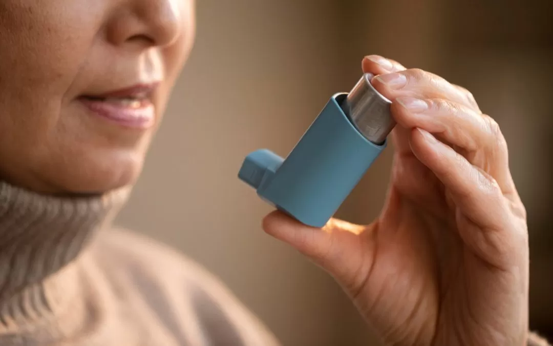 Asthma inhaler being used by a person for respiratory relief